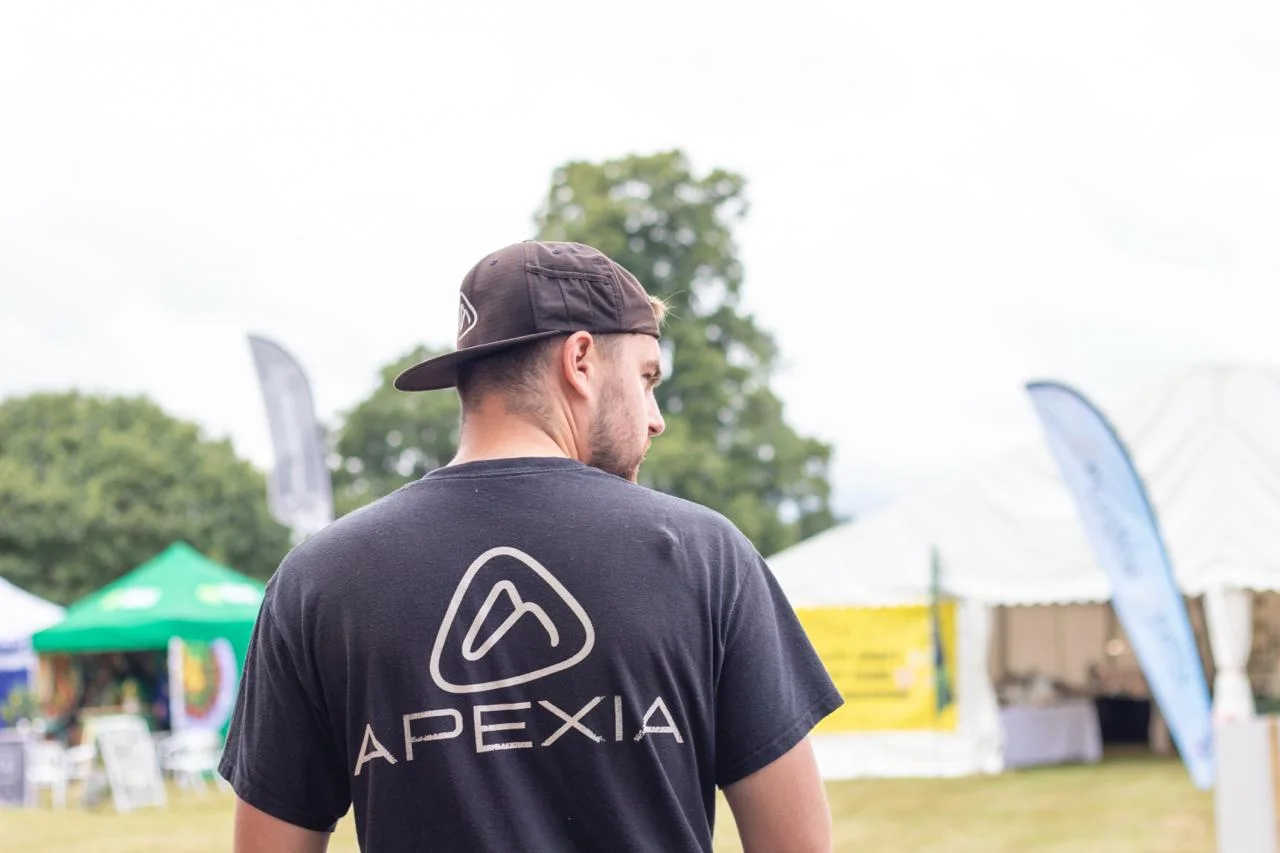 Joshua Stanley wearing an Apexia shirt at an outdoor event